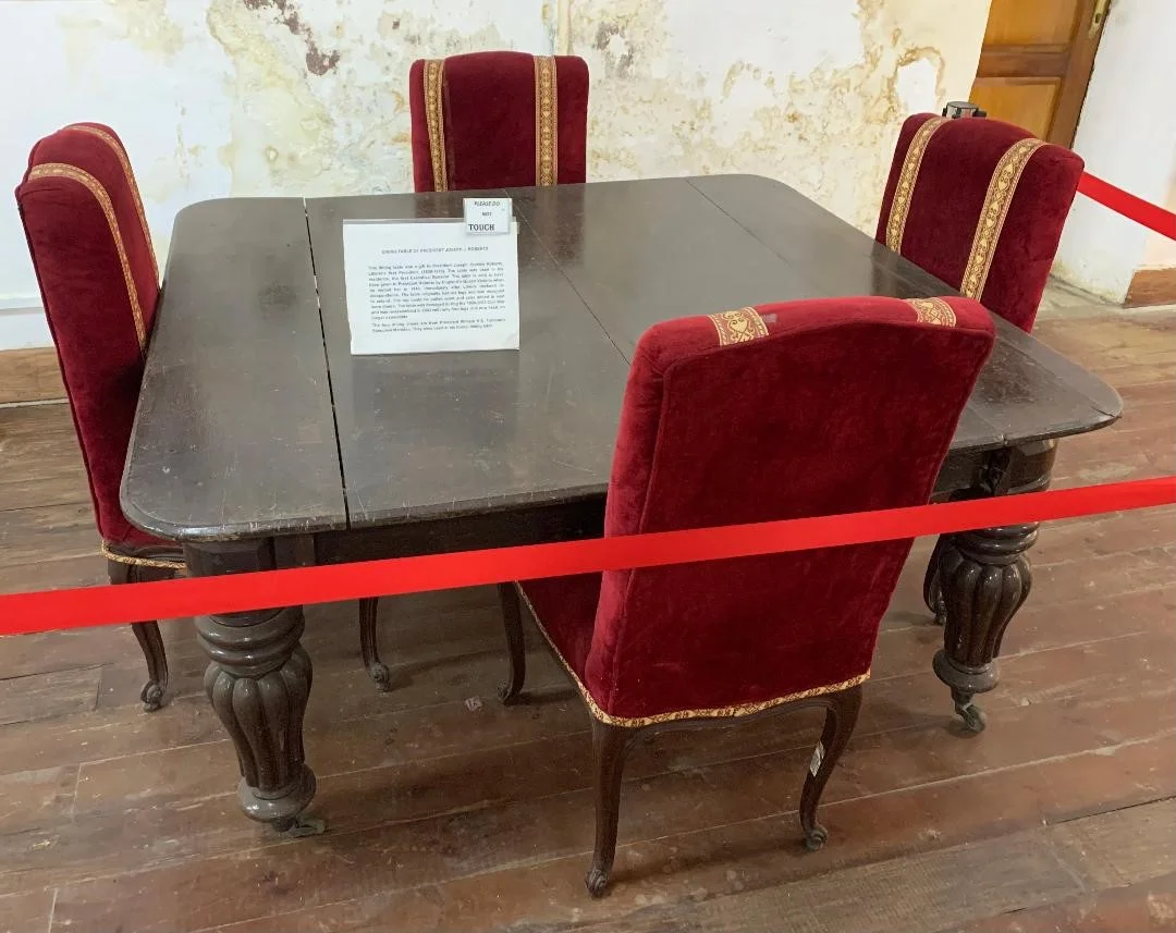 A gift from England's Queen Victoria to visiting Liberian President Joseph Jenkins Roberts in 1848, this dining table was used in his residence, the first Executive Mansion. The chairs are from President William V. S. Tubman's Executive Mansion where they were part of his formal dining table.