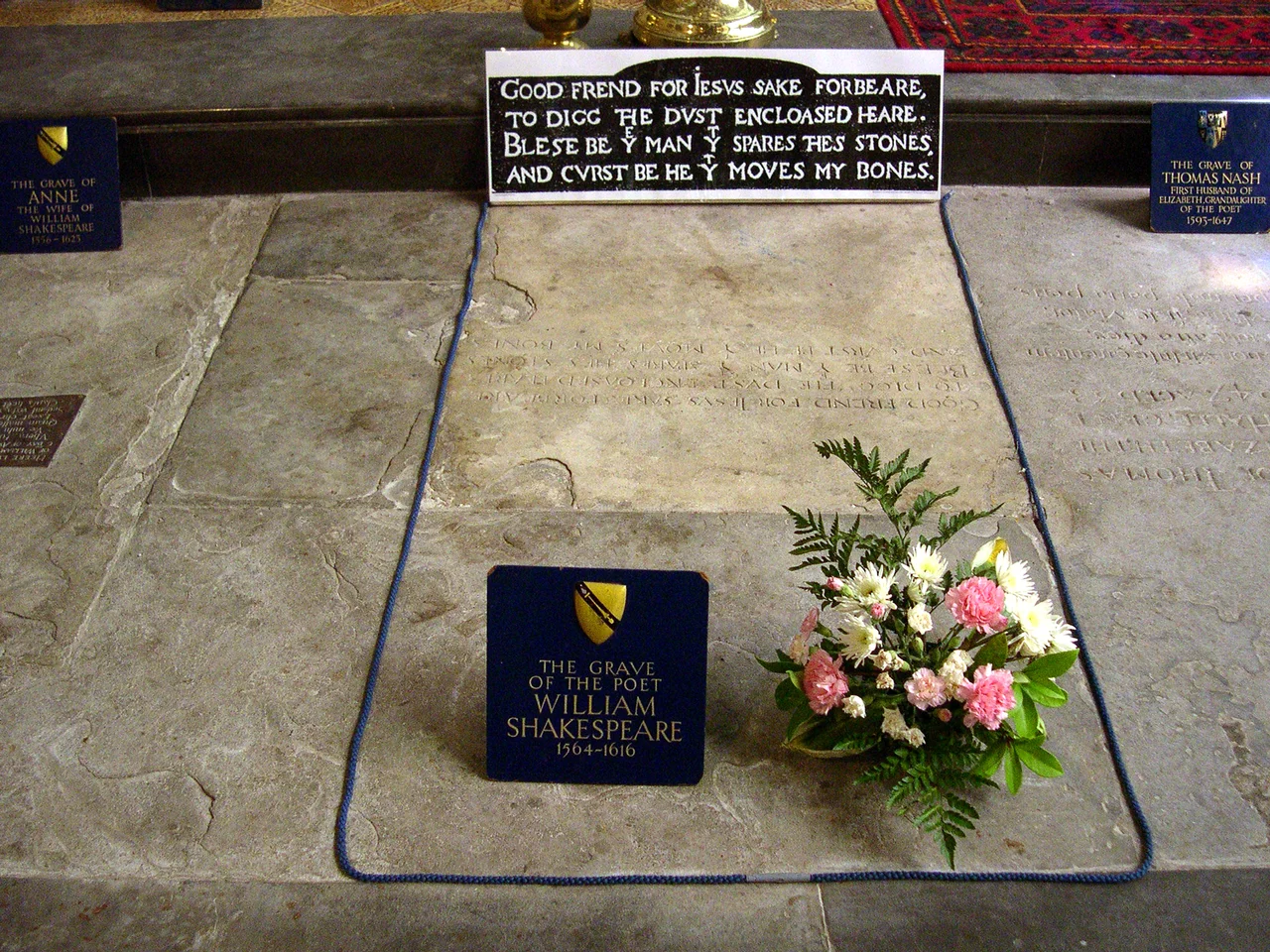 William Shakespeare's grave, Holy Trinity Church, Stratford-on-Avon, England
On his grave is written:
Good frend for İesus sake forbeare,
To digg the dvst encloased heare.
Bleste be þe man þt spares thes stones,
And cvrst be he þt moves my bones.
In modern English:
Good friend for Jesus sake forbear,
To dig the dust enclosed here.
Blessed be the man that spares these stones,
And cursed be he that moves my bones.